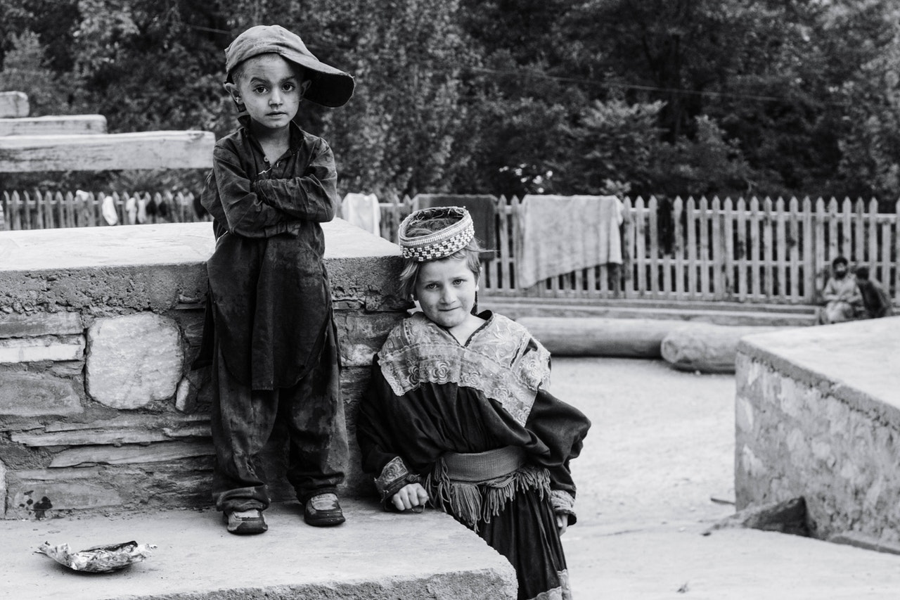 boy standing beside child standing beside concrete surface 3103373